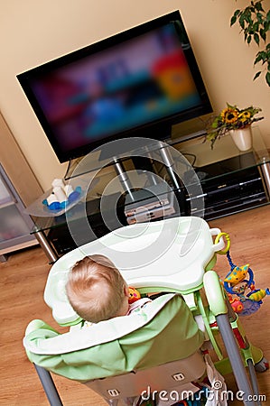 Baby girl watching tv Stock Photo