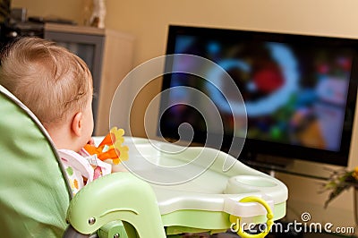 Baby girl watching tv Stock Photo