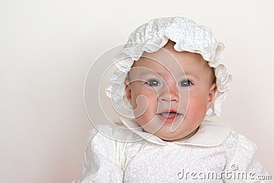 Baby girl wearing christening dress Stock Photo