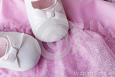 Baby girl white dancing shoes near leotards Stock Photo