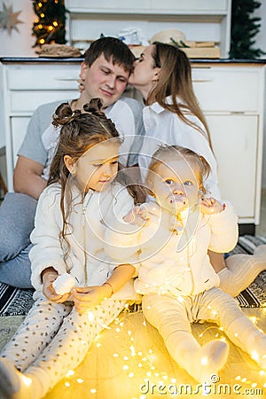 Baby girl in white and mother near Christmas Stock Photo