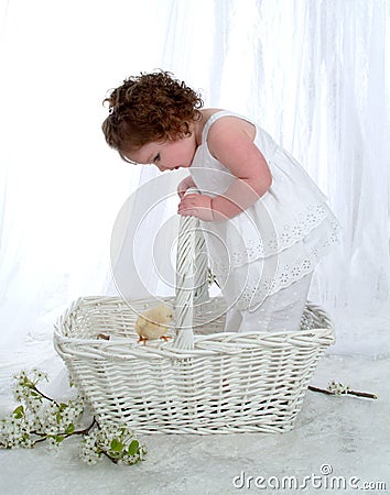 Baby Girl in Wicker Basket Stock Photo