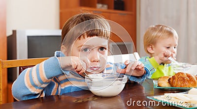 Baby girls eating dairy breakfast Stock Photo