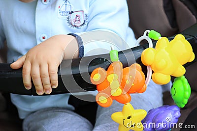 Baby hand close to baby toys Stock Photo