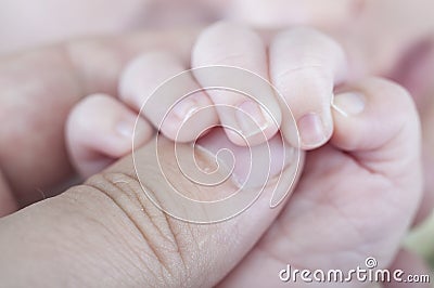 Baby, Hand of newborn. Hands of father and son united. Maternity Stock Photo