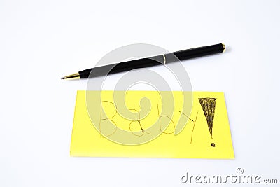 Baby handwrite with a pen on a yellow paper Stock Photo