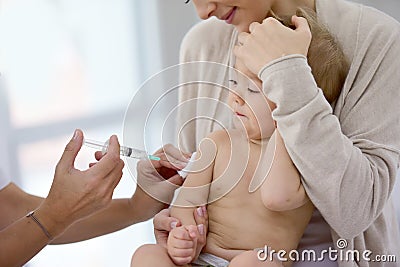 Baby with her mother getting vaccinated Stock Photo