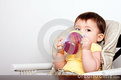 Baby infant drinking from sippy cup Stock Photo