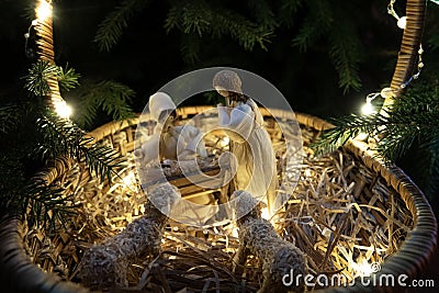 Baby Jesus resting on a manger with light from the star filters through window Stock Photo