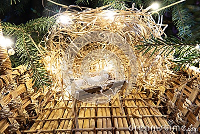 Baby Jesus resting on a manger with light from the star filters through window Stock Photo