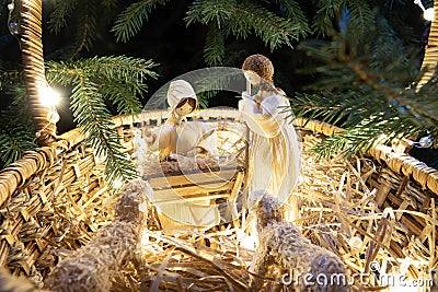 Baby Jesus resting on a manger with light from the star filters through window Stock Photo