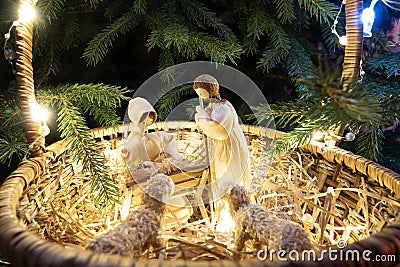 Baby Jesus resting on a manger with light from the star filters through window Stock Photo