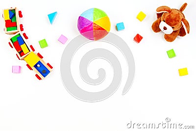 Baby kids toys background. Toy puppy, wooden train, colorful bricks on white table Stock Photo