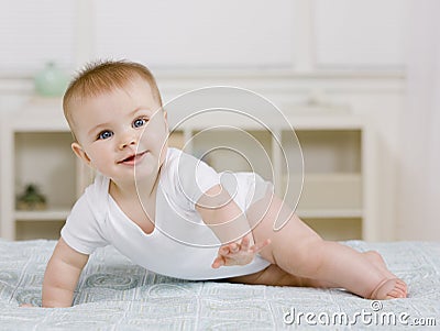 Baby laying on bed Stock Photo