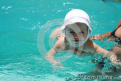 Baby learning to swim Stock Photo