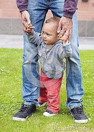 Baby learning to walk Stock Photo