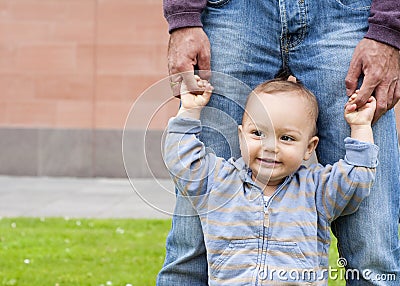 Baby learning to walk Stock Photo