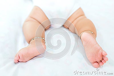 Baby legs on the bed, soft focus newborn tiny feet, lower body. Stock Photo