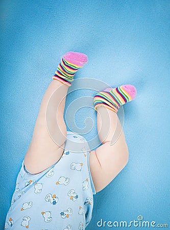 Baby legs on blue background Stock Photo