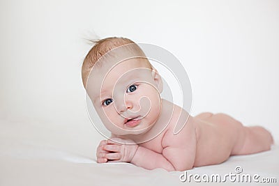 Baby lies on his stomach on a white background Stock Photo