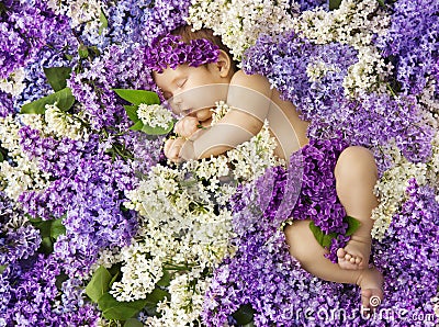 Baby in lilac flowers, newborn child greeting card, small new bo Stock Photo