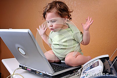 Baby looking at laptop baffled Stock Photo
