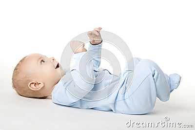 Baby Lying on Back, Happy Infant Kid Dressed in Blue Bodysuit Stock Photo