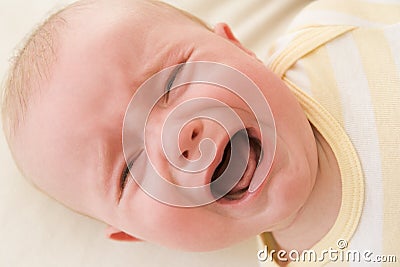 Baby lying indoors crying Stock Photo