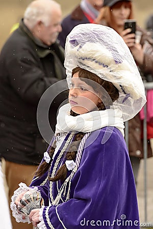 baby majorette wrapped up against rain at Carnival parade, Stuttgart Editorial Stock Photo