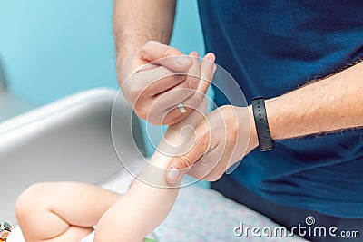 Baby massage closeup. Father and child. Newborn. Stock Photo