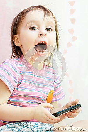 Baby with mobil telephone Stock Photo
