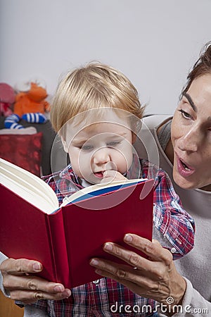 Baby and mom reading red book Stock Photo