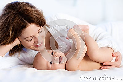 Baby and mother at home in bed. Mom and child. Stock Photo