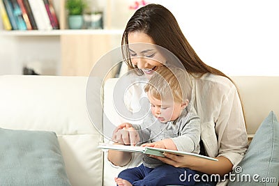 Baby and mother reading a book together Stock Photo