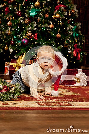 Baby near the Christmas tree. Little boy celebrati Stock Photo