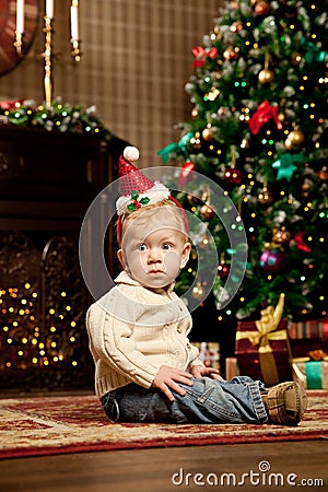 Baby near the Christmas tree. Little boy celebrati Stock Photo