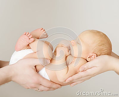 Baby newborn sleeping on parents family hands Stock Photo