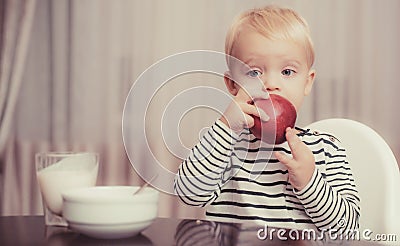 Baby nutrition. Eat healthy. Toddler having snack. Healthy nutrition. Vitamin concept. Child eat apple. Kid cute boy sit Stock Photo