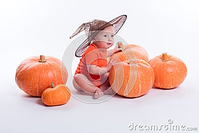 Baby in orange t-shirt on a white background sitting in a witche Stock Photo