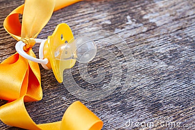 Baby pacifier on wooden table Stock Photo