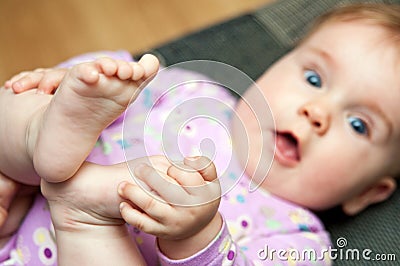 Baby play with toes Stock Photo