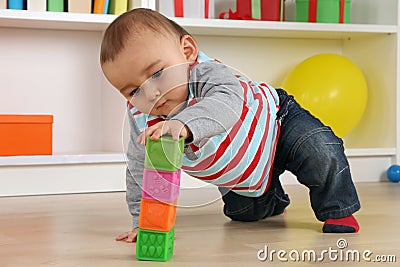 Baby playing with cubes Stock Photo