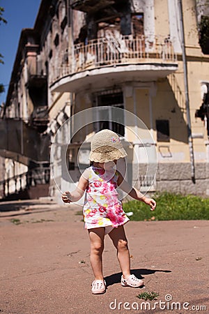 Baby playing near burnt building of City Police Department Editorial Stock Photo