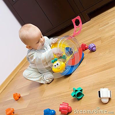 Baby playing with plastic toy Stock Photo