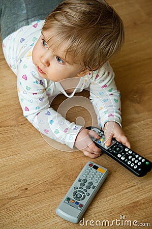 Baby playing with remote Stock Photo