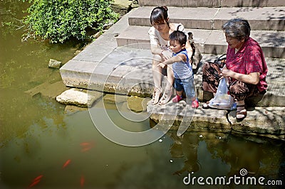 Baby playing at the waterside Stock Photo