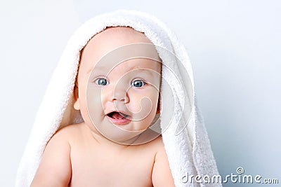 Baby portrait closeup,cute child face.Kid`s body care,girl in towel Stock Photo