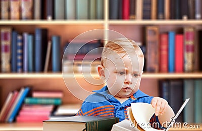 Baby reading in library Stock Photo