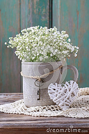 Baby`s breath gypsophilia paniculata in grey ceramic vase Stock Photo