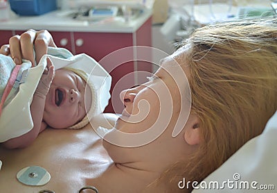 Baby`s first cry. Mother and newborn after childbirth Stock Photo